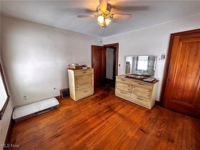 unfurnished bedroom with ceiling fan and dark hardwood / wood-style flooring