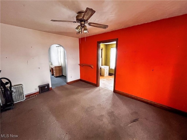 empty room with ceiling fan and concrete floors