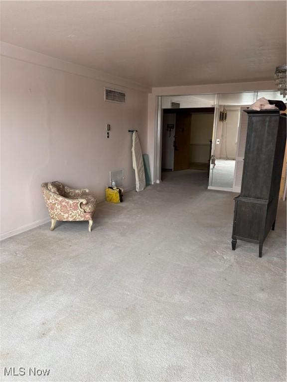 interior space featuring ornamental molding and carpet