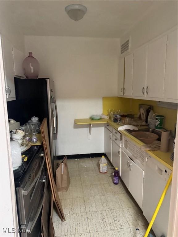 kitchen featuring sink, dishwasher, stainless steel range oven, and white cabinets