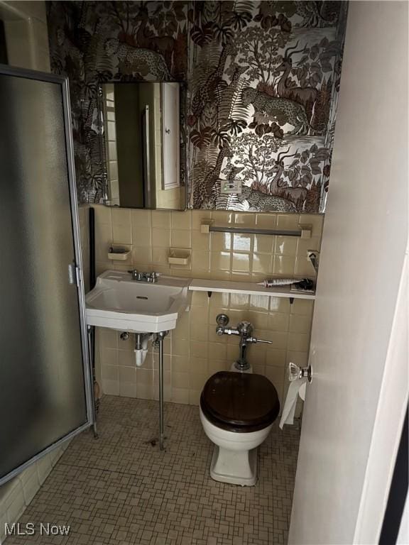 bathroom with tasteful backsplash, sink, tile patterned flooring, and toilet