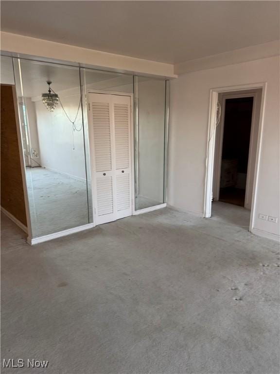 unfurnished bedroom with a closet and carpet flooring