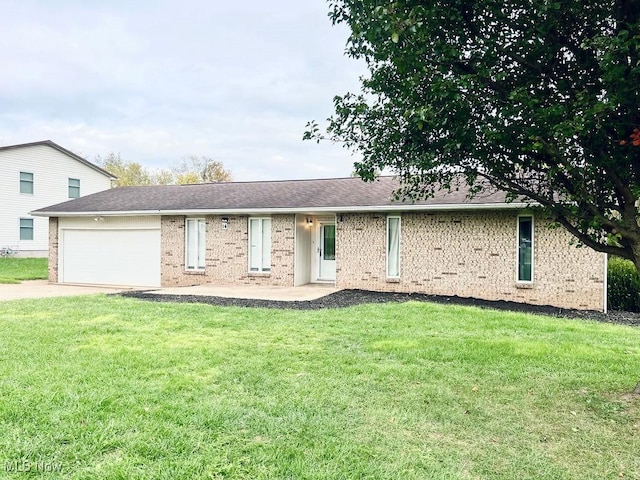 single story home with brick siding, driveway, an attached garage, and a front yard