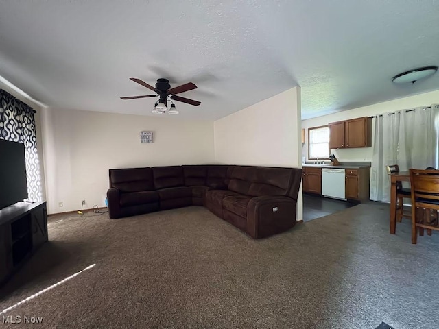 living room featuring dark carpet and ceiling fan