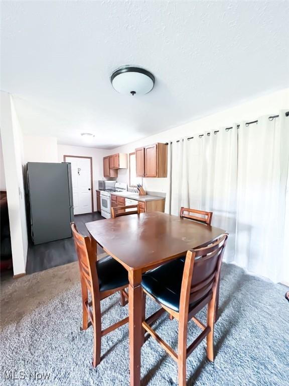 dining space featuring a textured ceiling