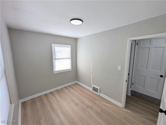 spare room featuring light hardwood / wood-style floors