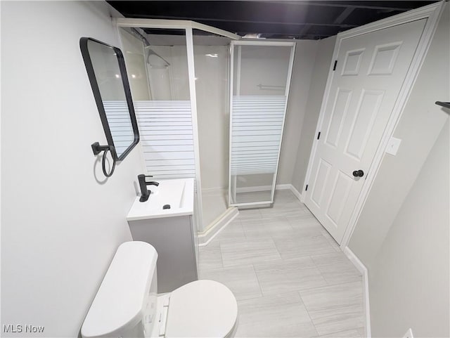 bathroom featuring an enclosed shower, vanity, tile patterned flooring, and toilet