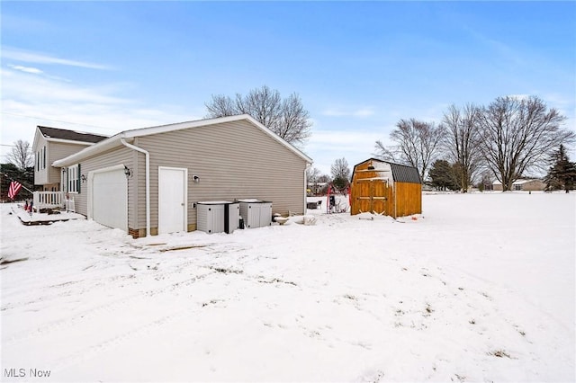 exterior space with a garage and a storage unit