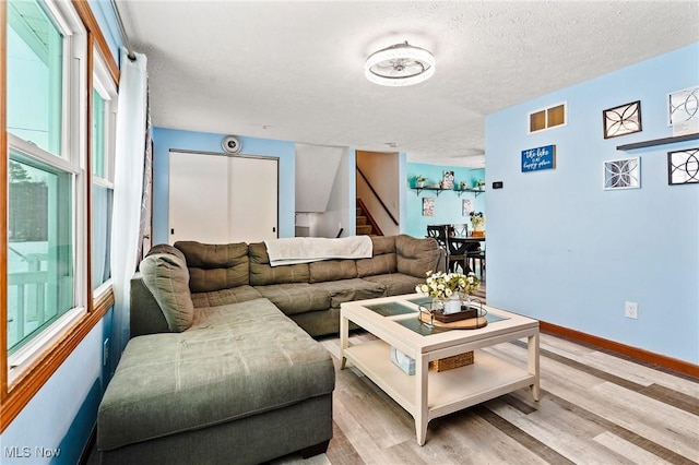 living room with a textured ceiling and hardwood / wood-style floors