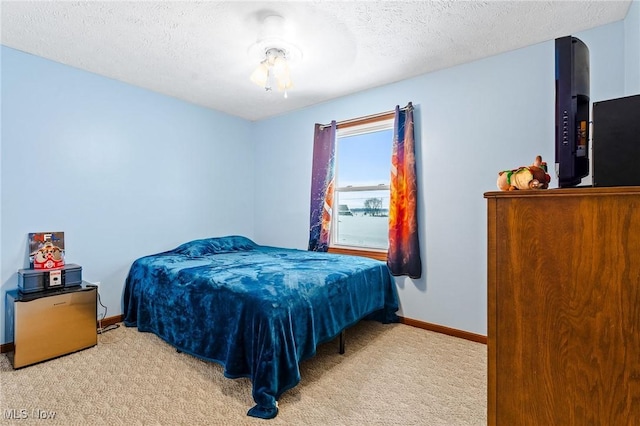 carpeted bedroom with a textured ceiling