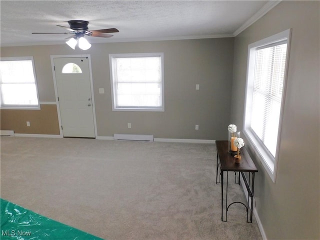 carpeted entrance foyer featuring a textured ceiling, baseboard heating, crown molding, and ceiling fan