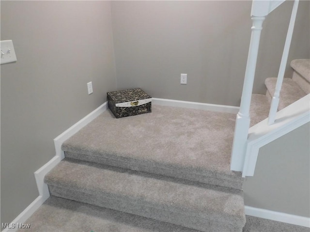 stairs with carpet flooring and decorative columns