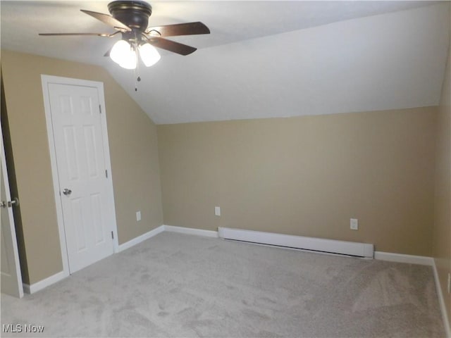 additional living space featuring ceiling fan, baseboard heating, light carpet, and vaulted ceiling