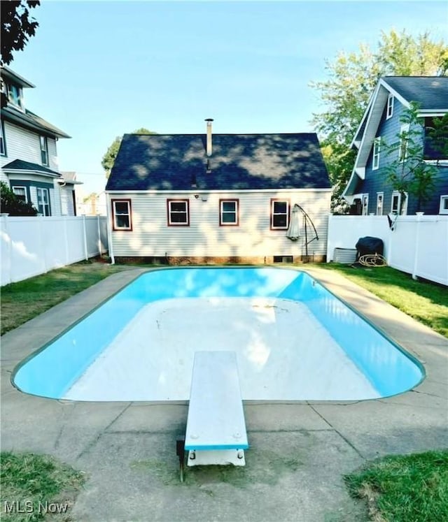 view of pool featuring a diving board and an outdoor structure