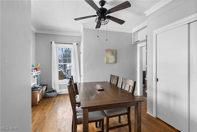 dining space featuring ceiling fan, dark hardwood / wood-style floors, and crown molding