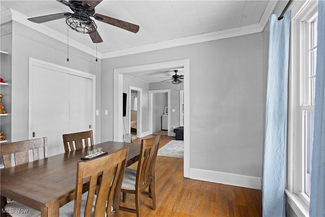 dining room featuring ceiling fan, wood-type flooring, ornamental molding, and a healthy amount of sunlight