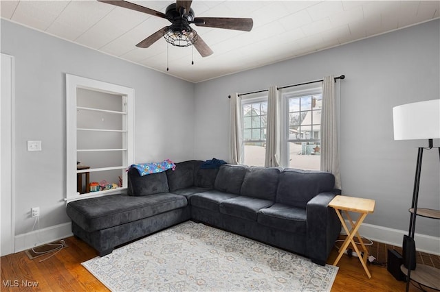 living room featuring ceiling fan and wood-type flooring