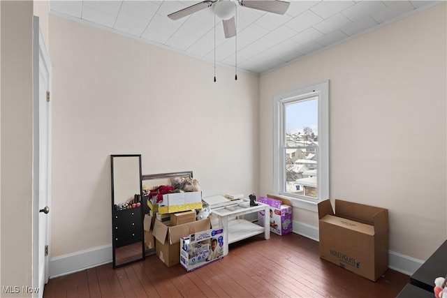 interior space with ceiling fan and dark hardwood / wood-style flooring