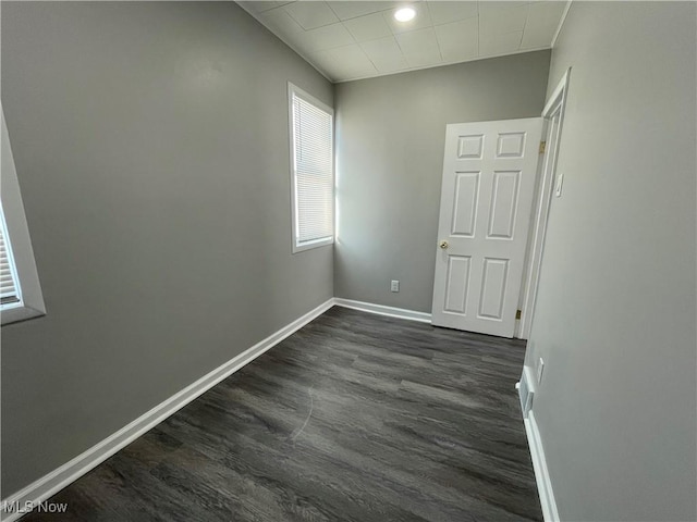 unfurnished room with dark hardwood / wood-style floors