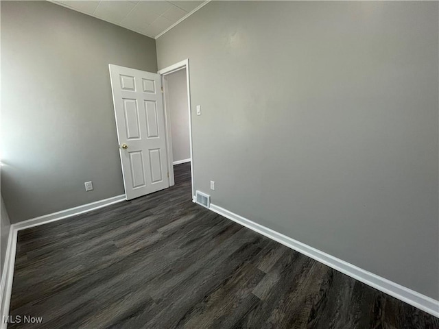 unfurnished room featuring dark hardwood / wood-style floors