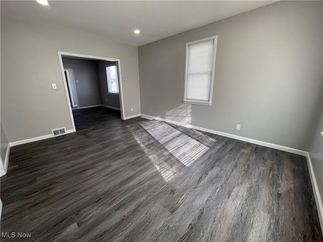 empty room with dark hardwood / wood-style floors