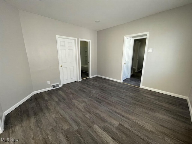 spare room featuring dark hardwood / wood-style flooring