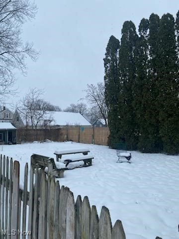 view of yard layered in snow