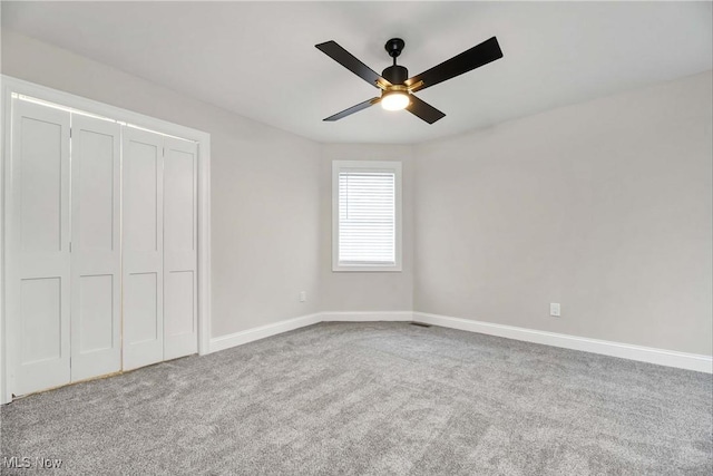 unfurnished bedroom featuring ceiling fan, a closet, and carpet flooring