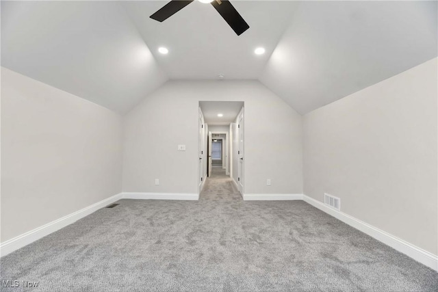 additional living space featuring vaulted ceiling, ceiling fan, and light colored carpet