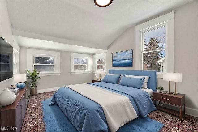 bedroom with lofted ceiling