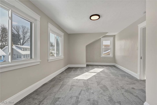 bonus room featuring light colored carpet