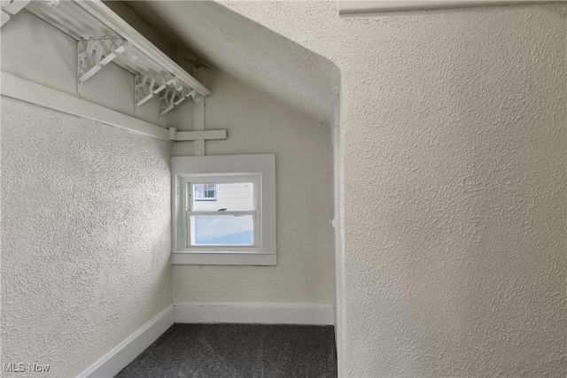 corridor featuring vaulted ceiling