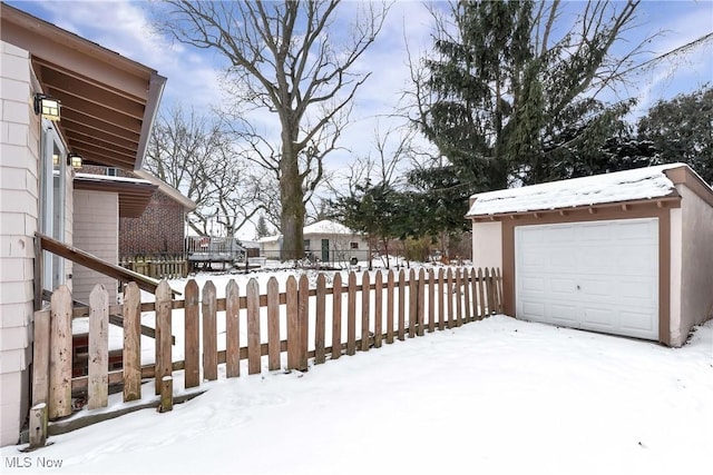 exterior space featuring a garage and an outbuilding