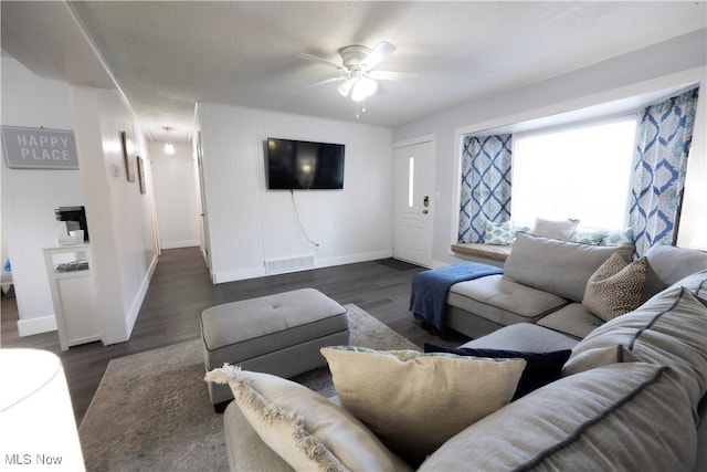 living room with ceiling fan and dark hardwood / wood-style flooring