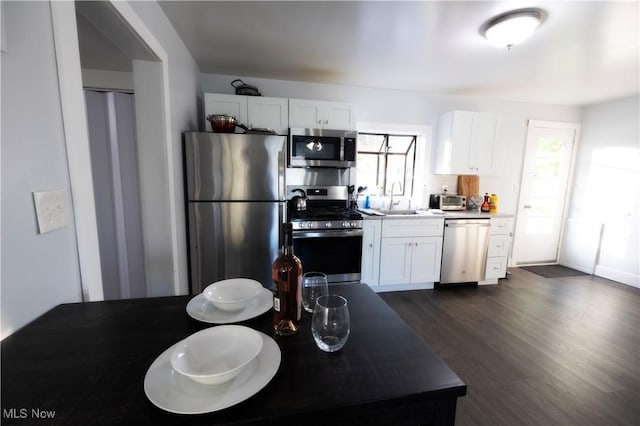 kitchen featuring white cabinets, dark wood-type flooring, sink, and stainless steel appliances