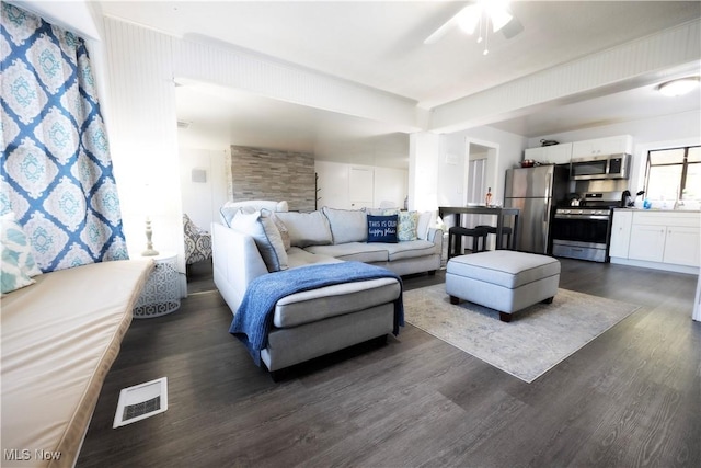 living room featuring ceiling fan and dark hardwood / wood-style flooring