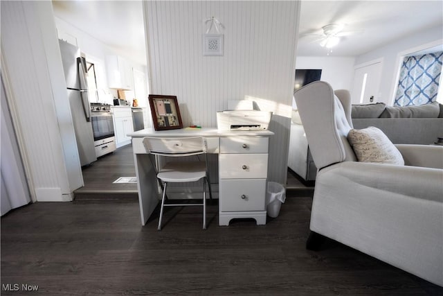 office space featuring ceiling fan, a wealth of natural light, and dark hardwood / wood-style flooring