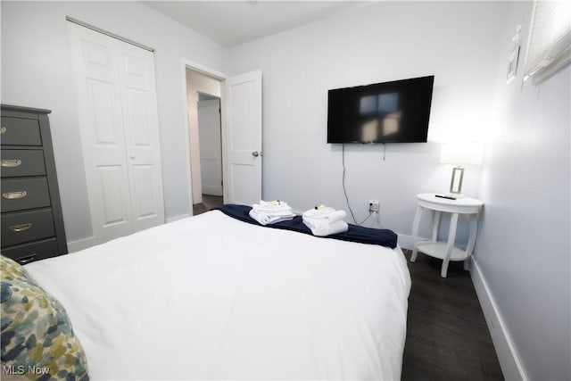 bedroom featuring a closet and dark hardwood / wood-style floors