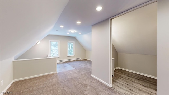 bonus room with baseboard heating and vaulted ceiling