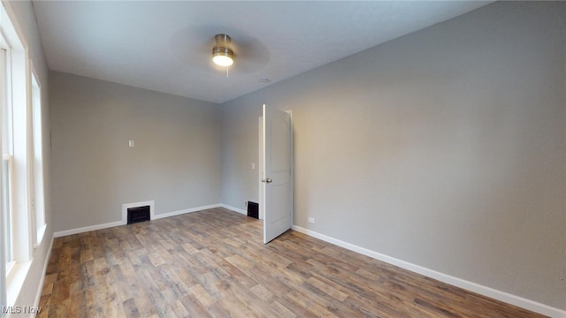 empty room with hardwood / wood-style flooring