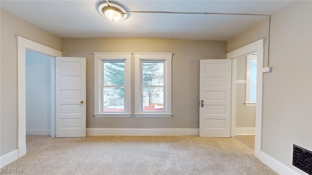 empty room with light colored carpet