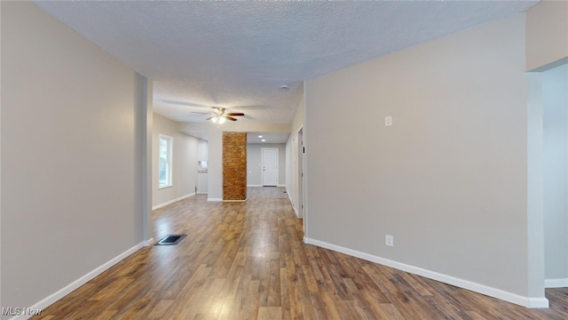 interior space with a textured ceiling, ceiling fan, and hardwood / wood-style flooring