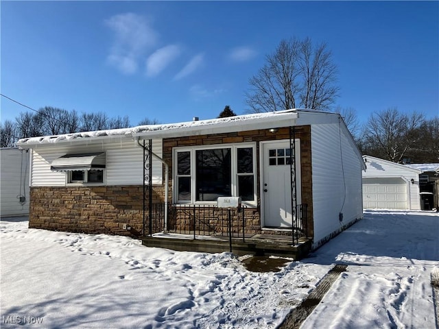 view of front facade featuring a garage and an outbuilding