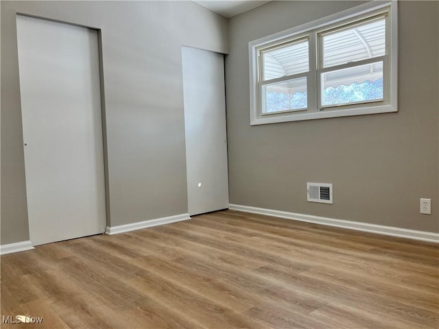 unfurnished bedroom featuring light wood-type flooring