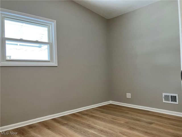 unfurnished room featuring hardwood / wood-style floors