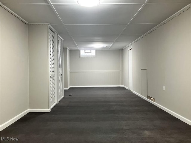 basement with a paneled ceiling