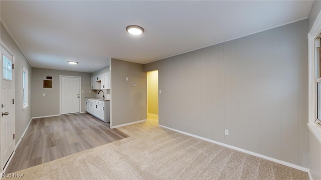 unfurnished living room featuring light colored carpet