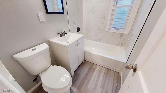 full bathroom featuring toilet, vanity, tiled shower / bath combo, hardwood / wood-style flooring, and a healthy amount of sunlight