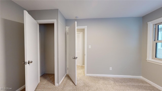 unfurnished bedroom with light carpet