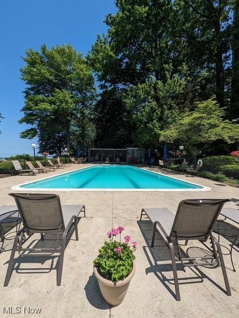 community pool featuring a patio area and fence